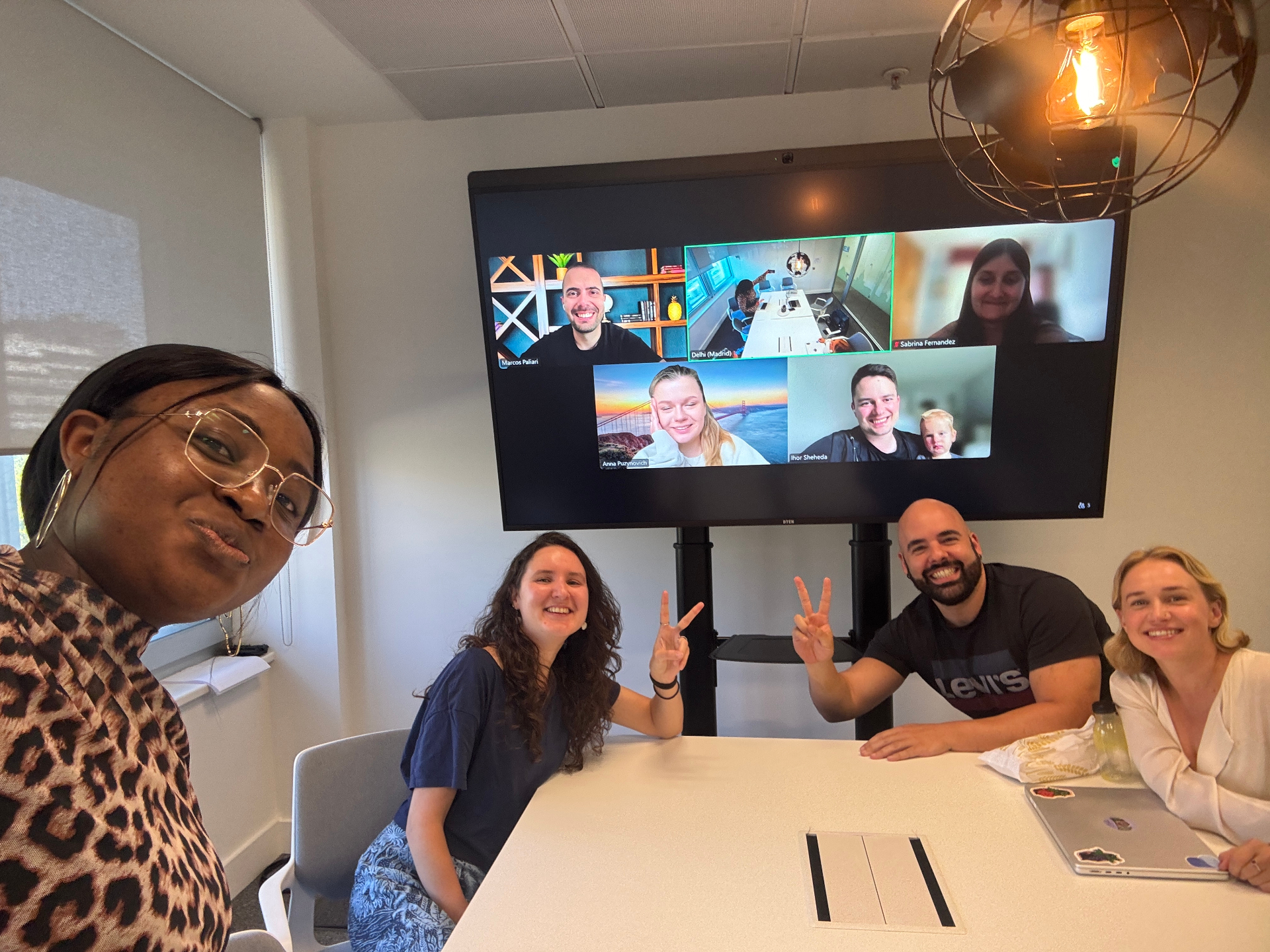 Team meeting with remote colleagues on screen