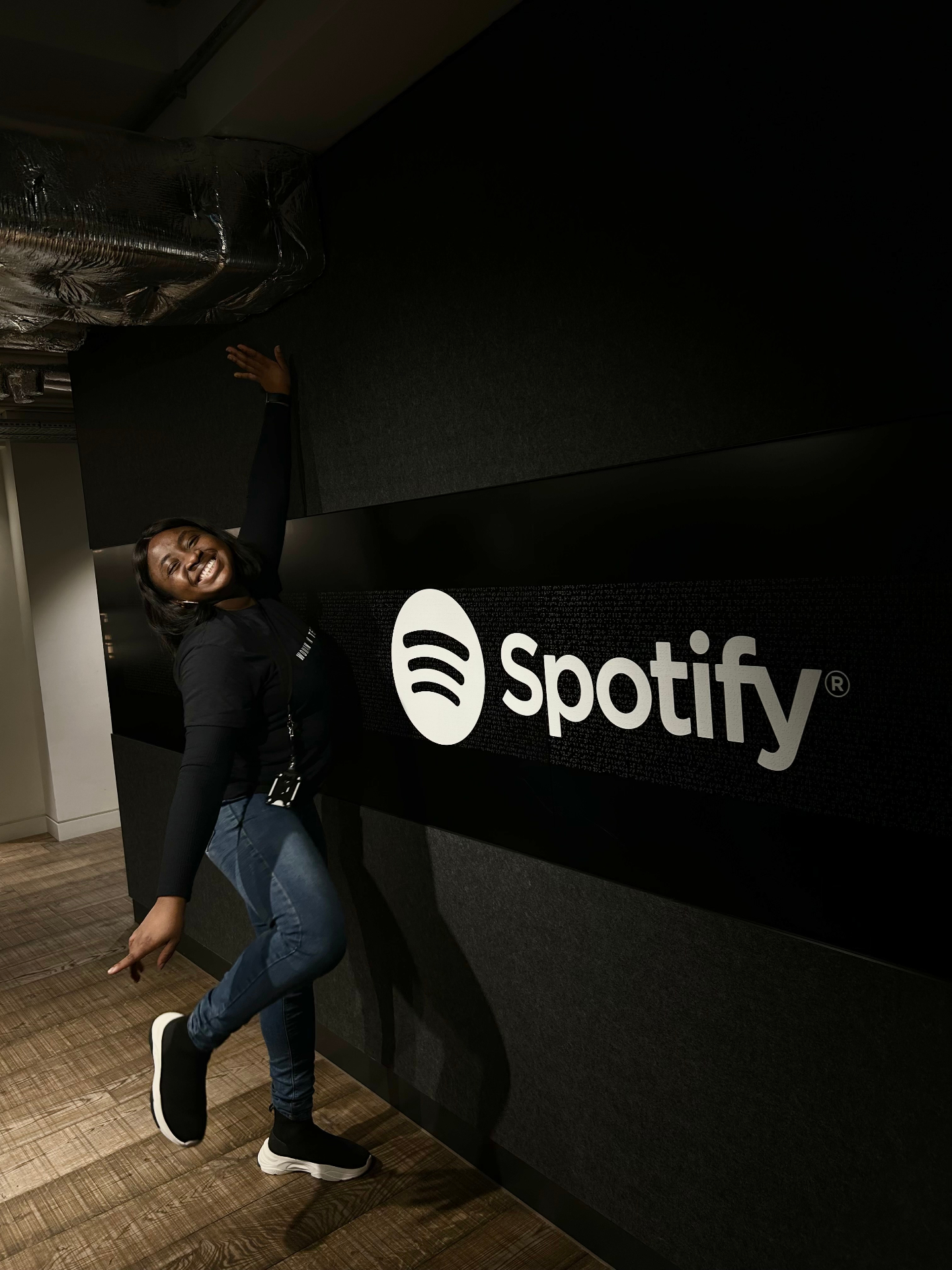 Posing by the Spotify logo at the London office