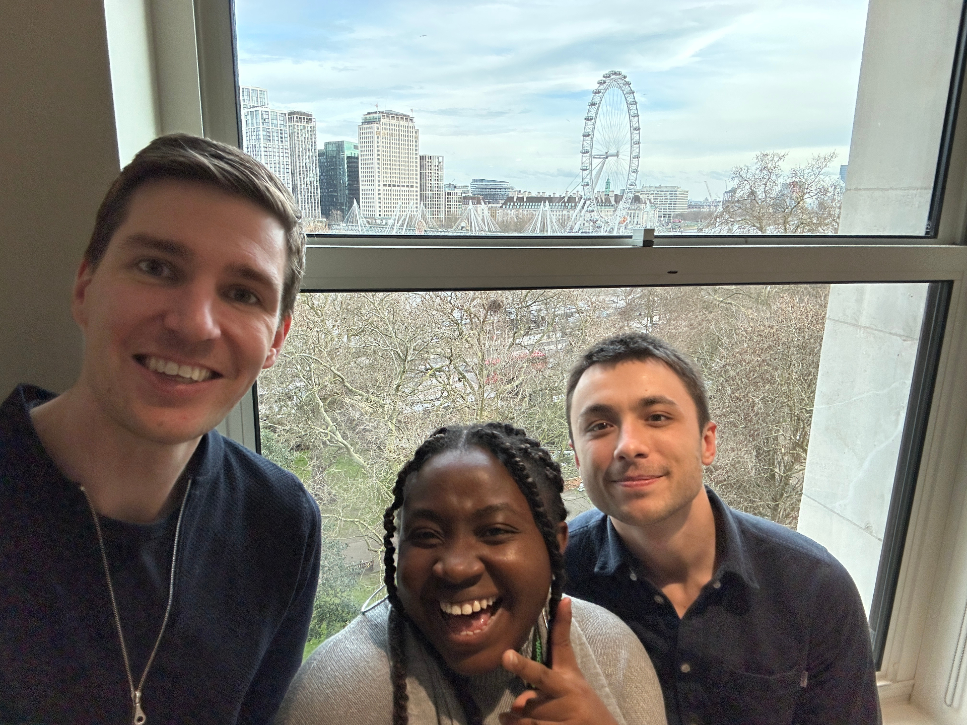 Team selfie with London Eye view from the office